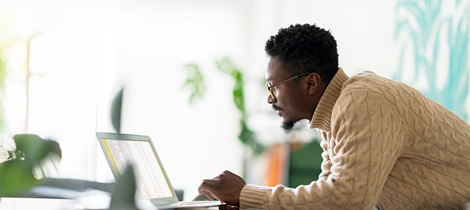 man looking at the laptop screen